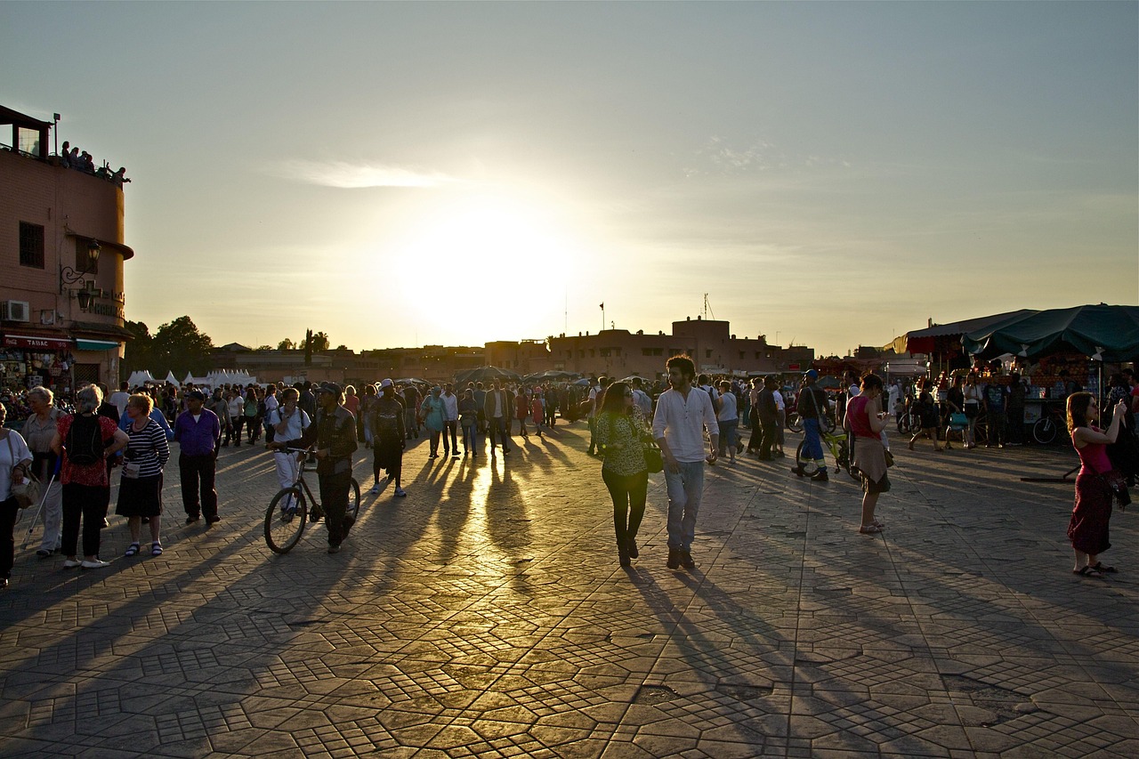 Jemaa el-Fnaa at Sunset – Marrakech by Night Tour Sunset over Jemaa el-Fnaa square with people walking and enjoying the evening in Marrakech