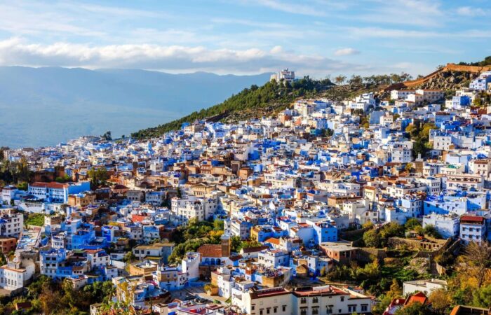 Collage of Morocco tour packages showing Sahara Desert, Marrakech, Atlas Mountains, and Essaouira.
