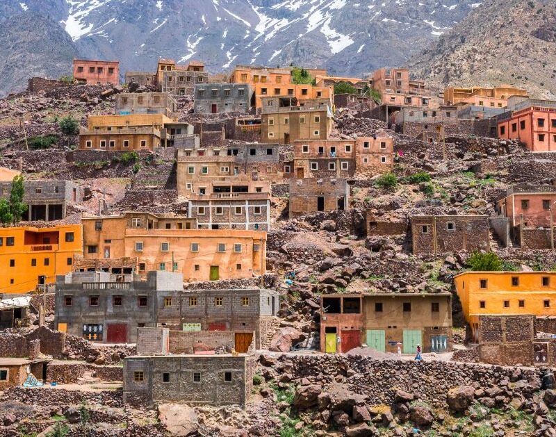 Colorful Berber village built on the hillside of the High Atlas Mountains in Morocco