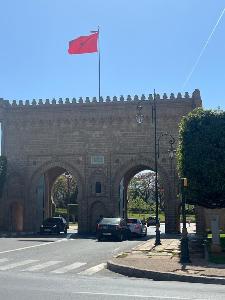 Historic city gate in Rabat with Moroccan flag