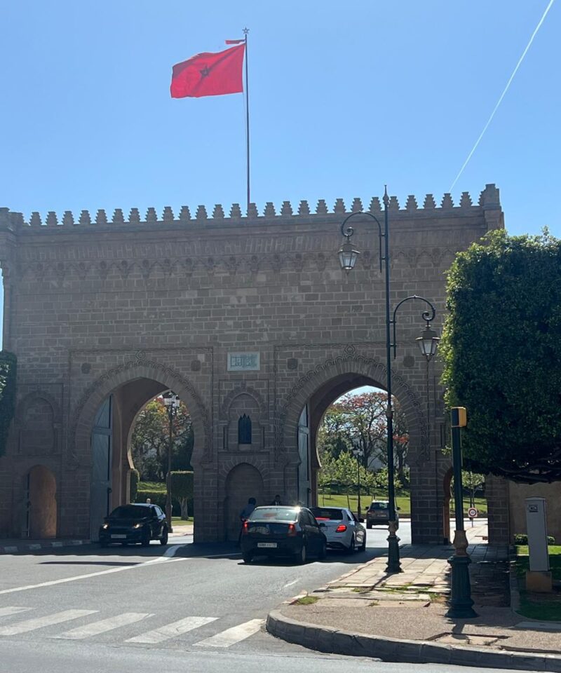 Historic city gate in Rabat with Moroccan flag