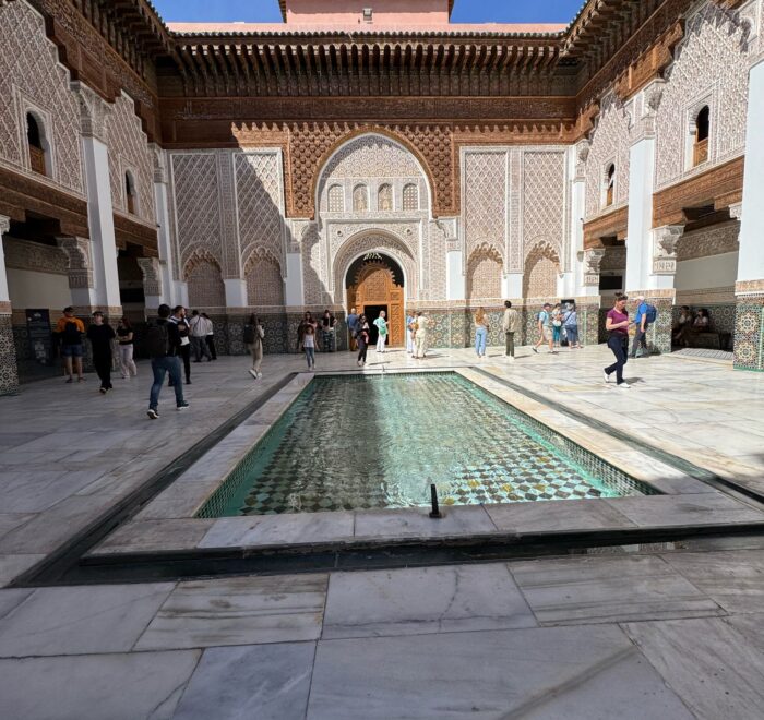 Courtyard of Medersa Ben Youssef in Marrakech with intricate Islamic architecture and a central fountain