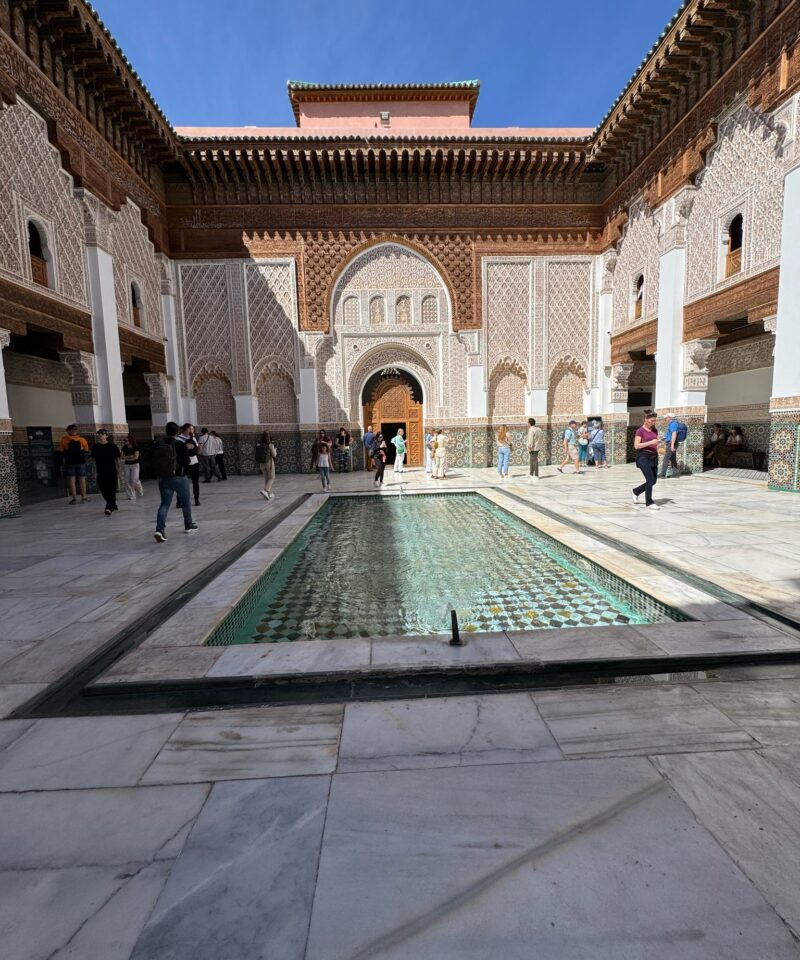 Courtyard of Medersa Ben Youssef in Marrakech with intricate Islamic architecture and a central fountain
