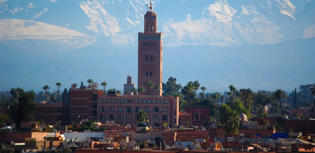 Koutoubia Mosque in Marrakech with the snow-covered Atlas Mountains in the background