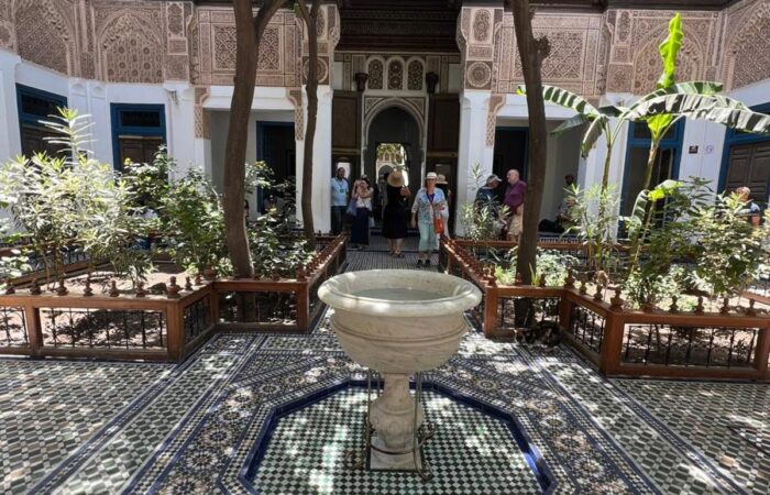 nterior courtyard of Bahia Palace in Marrakech with intricate Moroccan tilework and arches