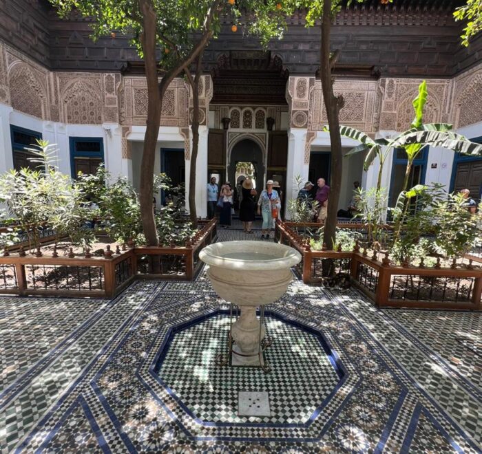 nterior courtyard of Bahia Palace in Marrakech with intricate Moroccan tilework and arches