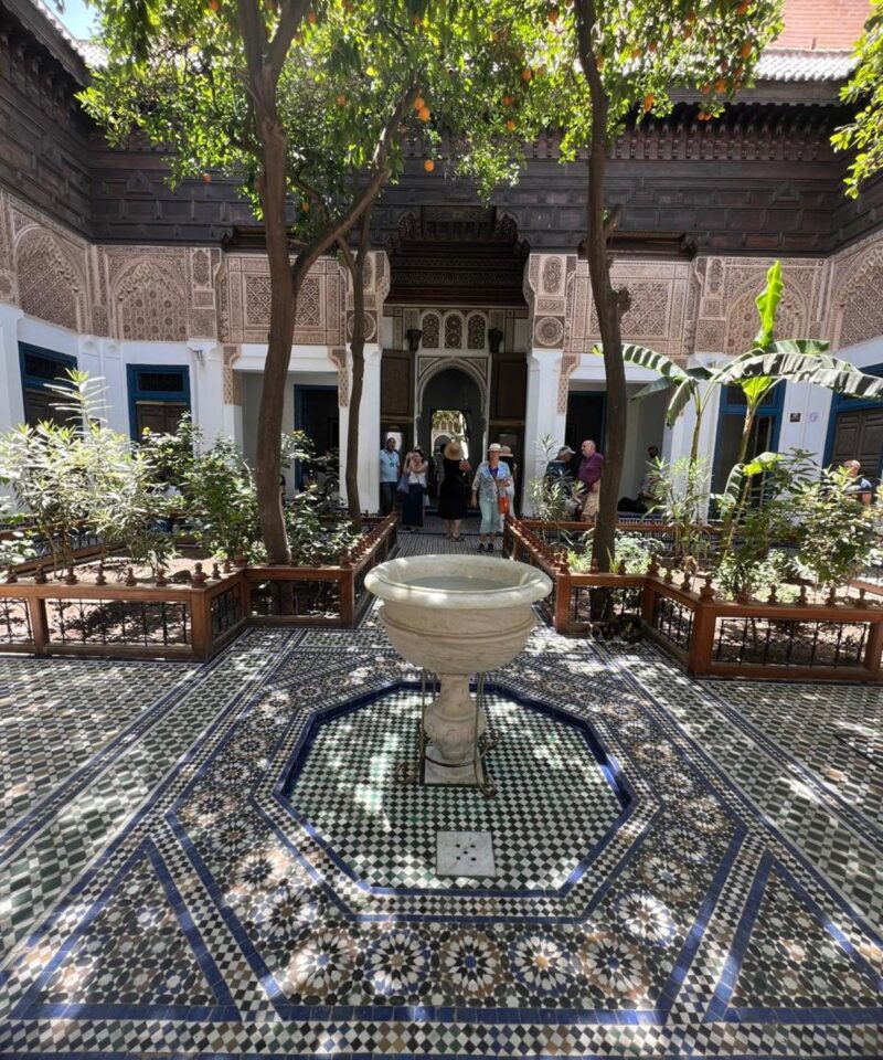nterior courtyard of Bahia Palace in Marrakech with intricate Moroccan tilework and arches