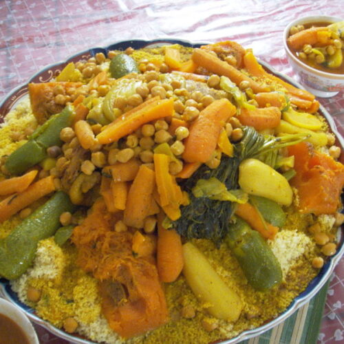 Traditional Moroccan couscous topped with assorted vegetables and chickpeas.