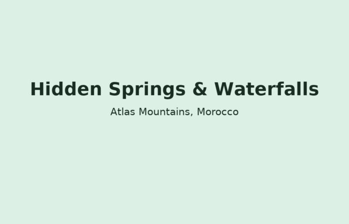 Hidden waterfall in Morocco’s Atlas Mountains with greenery and rocks, representing secret springs and natural pools.
