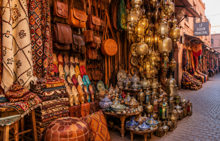 Traditional Moroccan rugs, leather goods, pottery and lanterns displayed in the famous Marrakech souk.